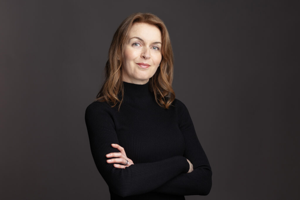 Female in black dress with auburn hair